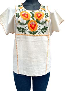 Mexican Embroidered Top.  Beautiful and rich embroideries.   The top would be used as casual or for fiesta cultural event.  Measurement: XLarge Petite Neck depth: 4 inches Neck Circumference: 26 inches Sleeve Width Circumference : 17 inches   Bust Circumference: 50 inches Waist Circumference: 50 inches Tunic Length: 25 inches Pre washed, will not shrink. Care: Machine Wash/Tumble dry If you have any question, I will be happy to assist you. Shipping Method: My first priority is to provide an excellent service.  During peak shipping season delays are expected, please apologize for any inconvenience shipping service could cause. I will always do my best to ship the item as soon as possible.  Thank you very much for your business. Folk Style Cotton Fabric With Embroidered Border, Cotton Embroidered Fabric With Folk Style, Folk Style Cotton Fabric With Intricate Embroidery, Cotton Folk Blouse With Machine Embroidery, Folk Style Cotton Blouse With Machine Embroidery, White Folk Style Fabric With Floral Embroidery, White Folk-style Fabric With Floral Embroidery, Multicolor Embroidered Folk Top With Embroidered Border, Bohemian Cotton Blouse With Machine Embroidery