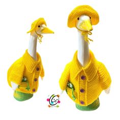 two knitted ducks wearing sweaters and hats with buttons on their heads, one in yellow