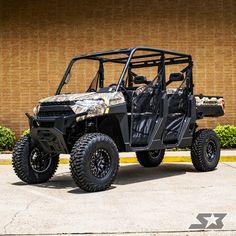 a polaris ranger is parked in front of a building