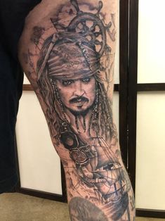 a man with a pirate tattoo on his leg