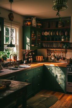 a kitchen filled with lots of green cabinets next to a sink and stove top oven