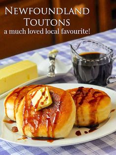 two pastries on a plate with syrup and butter