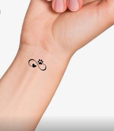 a woman's wrist with a small tattoo on it