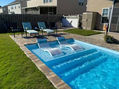 an empty swimming pool surrounded by lawn chairs