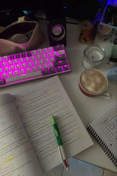 an open book sitting on top of a desk next to a keyboard