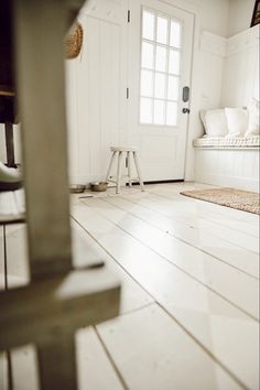 a room with white walls and wooden floors