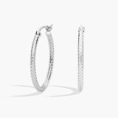 These small platinum hoop earrings have a subtly patterned, shimmer-cut surface that catches the light for just a glint of shine at the ear. The petite hoop size makes these earrings an everyday staple. Modern White Gold Diamond Cut Huggie Earrings, Silver Diamond Cut Hoop Earrings, Modern Round Diamond-cut Huggie Earrings, Silver Platinum Round Hoop Earrings, Modern Round Diamond Cut Huggie Earrings, Minimalist Silver Huggie Earrings With Diamond Cut, Modern Small Hoop Diamond Cut Earrings, Small Hoop White Gold Earrings With Shiny Finish, Small Silver Hoop Earrings With Diamond Cut