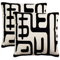 two black and white pillows sitting next to each other