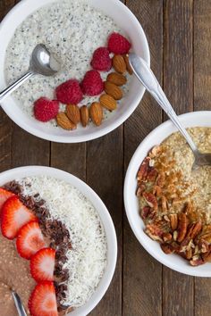 two bowls filled with oatmeal and fruit on top of a wooden table