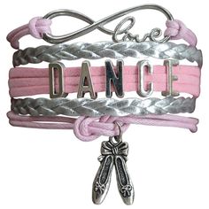 a pink and silver bracelet with the words dance on it, two pairs of scissors