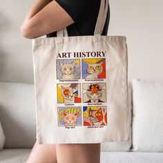 a woman carrying a tote bag with an art history design on the front and side