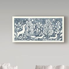 a blue and white wall hanging above a bed