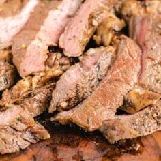 some meat is sitting on top of a cutting board