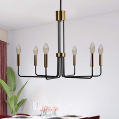 a chandelier hanging over a dining room table