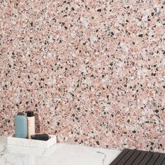 a bathroom with pink and black speckles on the wall