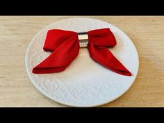 a white plate topped with a red bow