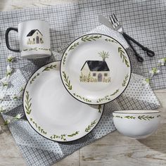 a table set with dishes and utensils on it