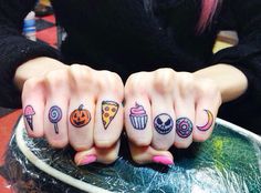 two girls with tattoos on their fingers are holding out their thumbnails in front of the camera