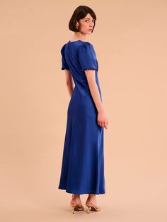 In a rich navy tone, Rosie is as effortless as she is elegant. Short balloon sleeves playfully draped in our signature recycled satin add a twist of texture to this classic neckline. Maxi in length and bra-friendly, she’s the perfect bridesmaid, wedding guest or date night dress. Rosie is the dress that does it all. Elegant Navy A-line Midi Dress, Date Night Dresses, Puffed Sleeves Dress, Shirt Skirt, Holiday Dresses, British Indian, Night Dress, Puff Sleeve, Denim Dress