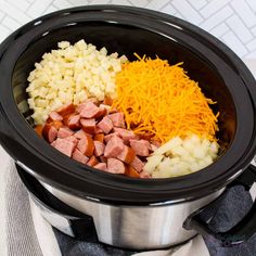 an image of food in the crock pot with cheese and meats on top