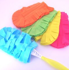 three different colored ruffles on top of each other next to a toothbrush