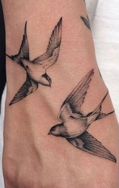 a woman's foot with two birds on it and the word love written in black ink