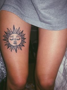 a woman's legs with sun and moon tattoo on her left leg, both showing