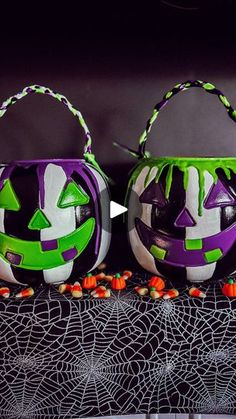 two decorated pumpkins sitting on top of a table