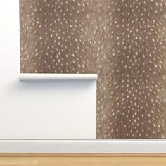 an animal print wallpaper in a living room with wood flooring and white walls