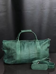 Genuine Python leather Traveling Bag/Snakeskin Duffel Bag PREMIUM QUALITY This handmade traveling, weekend or sports bag has a removable shoulder strap. It is as suitable for women as for men. Width: 55 cm/21,6 in Height: 36 cm/14,1 Depth: 24 cm/9,4 Interior Zipper Pocket All our products are 100% handmade, we always try to create interesting ideas to make your style unique. We use only the highest quality materials and accessories from around the world and only best leather from Indonesia. Befo Luxury Crossbody Travel Bag With Leather Handles, Luxury Weekender Shoulder Bag With Large Capacity, Luxury Leather Handle Crossbody Travel Bag, Everyday Luxury Large Capacity Rectangular Shoulder Bag, Luxury Textured Leather Bag For On-the-go, Luxury Large Capacity Shoulder Weekender Bag, Luxury Green Pouch Shoulder Bag, High-end Travel Satchel In Pouch Shape, High-end Travel Satchel Pouch