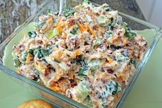 a casserole dish with cheese and other toppings in a glass container on a table