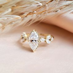 a diamond ring sitting on top of a feather