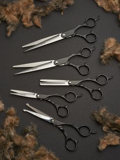 five pairs of scissors are laying on some fur