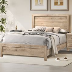 a bedroom scene with focus on the bed and two framed pictures over the headboard