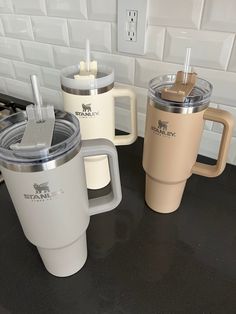 three coffee cups sitting on top of a counter