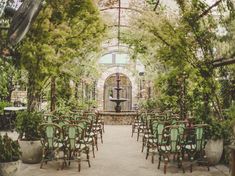 the inside of a greenhouse filled with lots of green chairs