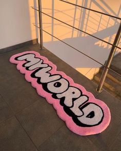 a pink welcome mat with the word obama on it in front of stairs and railings