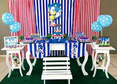 the table is set up with balloons and decorations