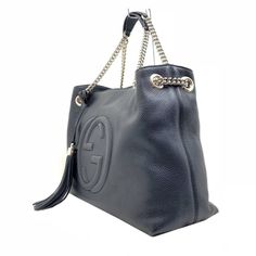 This Gucci black leather bag features the interlocking GG logo. It is large enough to carry all of your essentials in style. The shoulder straps are made of gold chain, but come with leather shoulder padding for comfort. This designer handbag instantly elevates your everyday look. Includes authenticity cards and Gucci dust bag.    Model: 536196  Black Leather  Embossed interlocking G Detachable leather tassel  Double chain shoulder straps with leather shoulder pad  Inside hook closure  Light fin Modern Gucci Bag With Branded Hardware, Modern Gucci Shoulder Bag For Shopping, Everyday Gucci Shoulder Bag With Gold-tone Hardware, Gucci Crossbody Shoulder Bag With Logo Hardware, Gucci Rectangular Bag With Logo Hardware, Gucci Leather Shoulder Bag With Logo Hardware, Gucci Shoulder Bag With Logo Hardware For Everyday Use, Gucci Crossbody Bag With Logo, Everyday Gucci Double Handle Shoulder Bag