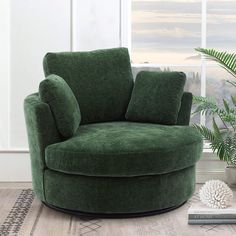 a green chair sitting in front of a window