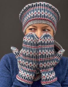 a man wearing mittens and gloves covers his mouth