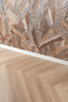 a wooden floor in front of a wall with an artistic painting on it's side