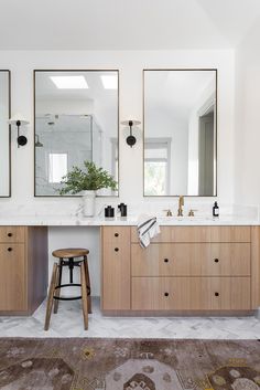 a bathroom with two sinks and mirrors on the wall above it is an ad for self - care today