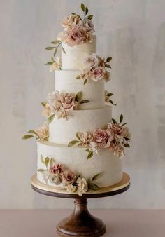 a three tiered cake with flowers on it