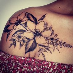 a woman's shoulder with flowers on it