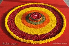 an arrangement of flowers arranged in the shape of a flowerpot on a red carpet