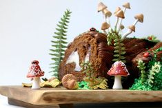 a cake with mushrooms and plants on it