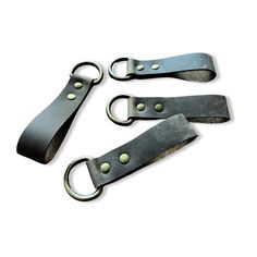 three black leather straps with metal hooks