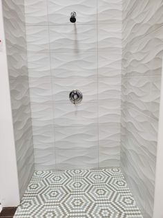 a bathroom with a shower and tiled floor