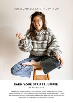 a woman sitting on top of a stool with her hands in the air and smiling